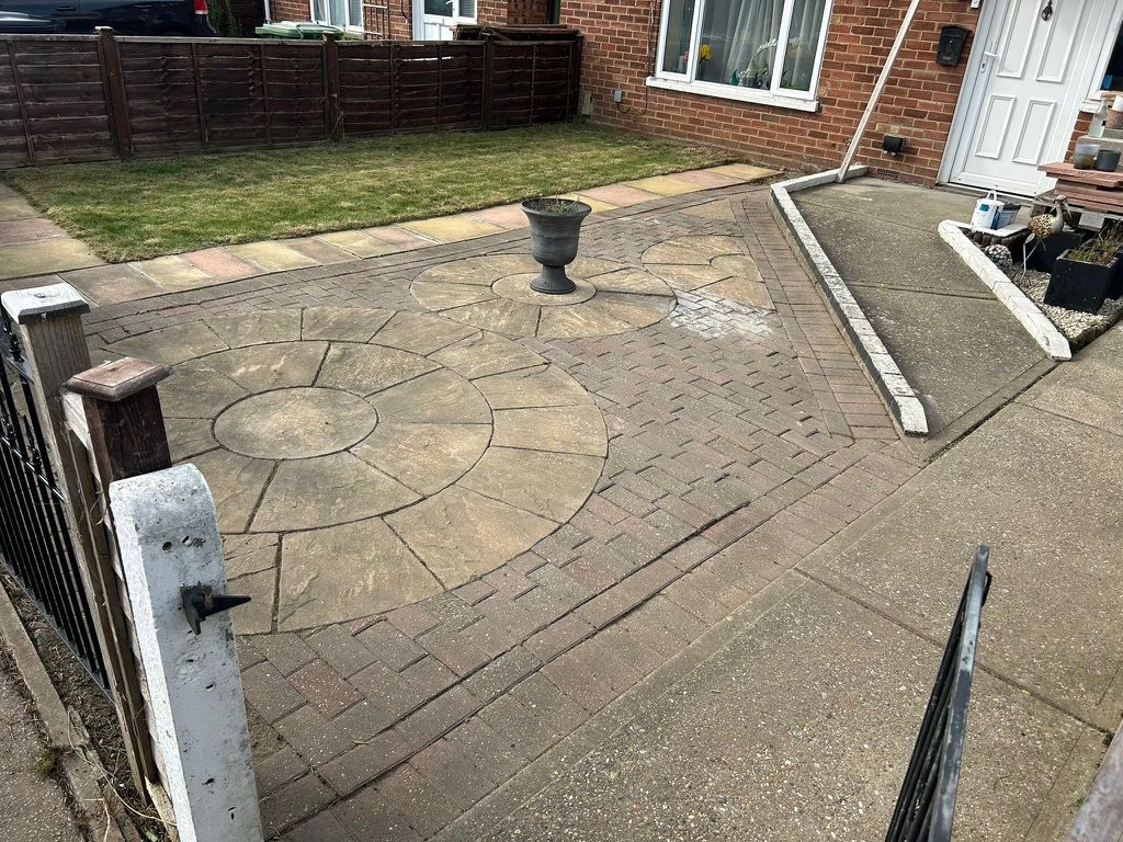 Restored front garden with circular paved patio and laid lawn