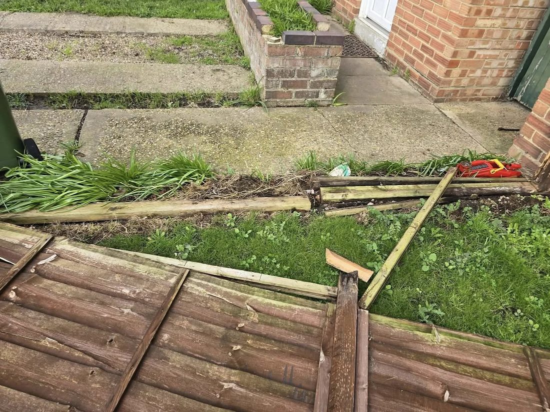 Broken fence panels on the ground